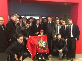 The Ottawa Senators pose with Jonathan Pitre during a visit in Minneapolis on Wednesday, March 29, 2017.