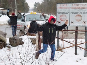 An asylum claimant crosses the border into Canada from the United States, Tuesday, March 28, 2017 near Hemmingford, Que. (THE CANADIAN PRESS/Paul Chiasson)