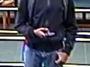 Security camera image of a man wanted in bank hold-up investigation. (HANDOUT)