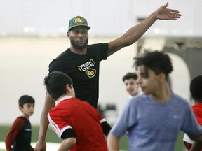 Edmonton Eskimo Adarius Bowman participates in a junior high school flag football clinic at Commonwealth Stadium in Edmonton on February 2, 2017.