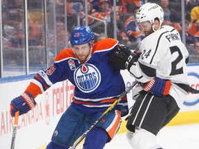 Los Angeles Kings' Derek Forbort (24) vies for the puck with Edmonton Oilers' Leon Draisaitl (29) during second period NHL action in Edmonton, Alta., on Tuesday, March 28, 2017.