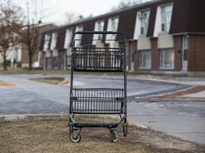An abandoned grocery cart sits in front of Toronto Community Housing properties along Wakunda Place in Toronto, earlier this month. A new landlord registration fee is waived for social and non-profit housing providers, including the city-owned TCHC. (ERNEST DOROSZUK/TORONTO SUN)