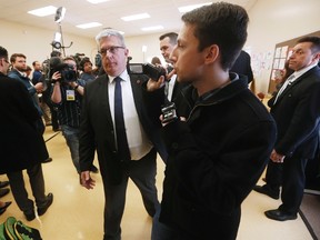 A heckler is escorted out of the room as Prime Minister Justin Trudeau speaks at a YMCA-YWCA day care centre in Winnipeg, Wednesday, March 29, 2017. Trudeau was in Winnipeg to highlight their plan to spend $7 billion over 10 years to create more child care spaces across Canada. (THE CANADIAN PRESS/John Woods)