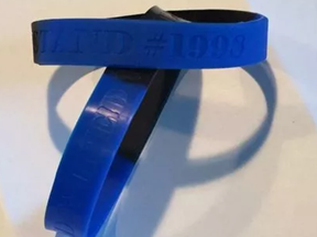 Ottawa police officers have purchased wristbands expressing solidarity with an officer accused of manslaughter in the death of Abdirahman Abdi, which bear the words 'united we stand,' 'divided we fall' and the number 1998, which is Const. Daniel Montsion's badge number.
