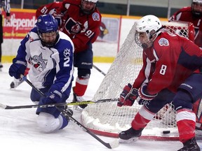 Joe Mazur of the Sudbury Nickel Capital Wolves tries to shoot the puck past North Bay Trappers defenceman Payton Vescio during the Central Region Midget AAA Championship in Sudbury on Wednesday night. Gino Donato/The Sudbury Star