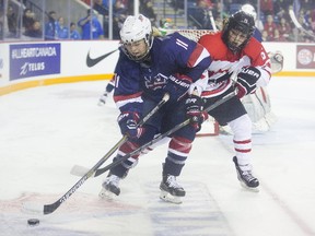 Ryleigh Houston of Canada (right) battles Sydney Brodt of the USA for the puck during the Under-18 Women's World Championship in St. Catharines on Jan. 11, 2016. Houston school, the University of North Dakota, cut the women's hockey program on Wednesday. (Julie Jocsak/Postmedia Network/Files)