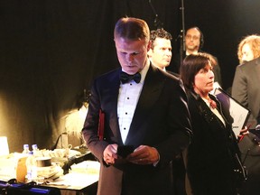 In this Feb. 26, 2017, file photo, PwC accountant Brian Cullinan, center, holds red envelopes under his arm while using his cell phone backstage at the Oscars at the Dolby Theatre in Los Angeles. PwC accountants won’t be allowed to have their cellphones backstage during future Oscar telecasts. Film academy president Cheryl Boone Isaacs sent an email to academy members Wednesday, March 29, 2017, detailing the new protocols established for announcing Oscar winners after the best-picture flub at last month’s Academy Awards. Boone Isaacs blamed Cullinan’s distraction for the error. (Photo by Matt Sayles/Invision/AP, File)