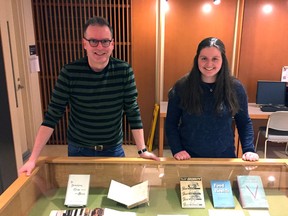 Queen's University history professor Steven Maynard and second-year student Jessie Cooke stand behind one of the display cases of cookbooks that comprise the new exhibit, "The Taste of the Library," which opens Thursday on the second floor, in the Jordan Rare Books and Special Collections, of the university's Douglas Library, 93 University Ave.