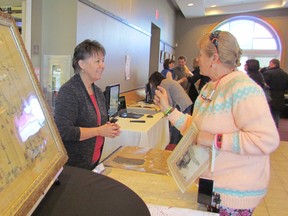 Connie Bell, left, supervisor of the Oil Museum of Canada, is shown in this file photo talking with Joanne Osborne, of Petrolia, at a Petrolia Heritage Committee Open House held last year. This week, the oil museum, located in Oil Springs,  received the Petroleum History Society's 2016 Preservation Award. (File photo)
