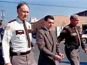 In this Nov. 2, 1987, file photo, convicted killer Donald Harvey, centre, is led back to jail by Laurel County, Ky., Sheriff Floyd Brummett, left, and an unidentified deputy after pleading guilty to eight murder charges and one voluntary manslaughter charge in London, Ky.