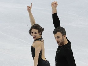 Meagan Duhamel and Eric Radford, of Canada, skate their short program at the World figure skating championships in Helsinki, Finland, on Wednesday, March 29, 2017. (AP Photo/Ivan Sekretarev)