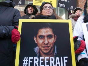 Saudi Arabia has again delayed a planned flogging of a blogger, according to a report from Amnesty International. Ensaf Haidar, wife of blogger Raif Badawi, takes part in a rally for his freedom, Tuesday, January 13, 2015 in Montreal. (THE CANADIAN PRESS/Ryan Remiorz)