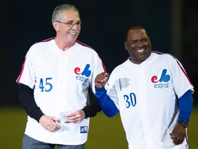 Former Montreal Expos players Steve Rogers (left) and Tim Raines share a laugh during a ceremony prior to a pre-season game in Montreal between the Toronto Blue Jays and the New York Mets on March 28, 2014. (Paul Chiasson/The Canadian Press/Files)