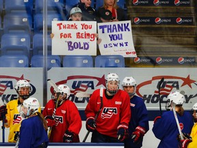 United States teammates practice with fans holding signs of support in preparation for the IIHF Women's World Championship in Plymouth, Mich., on Thursday, March 30, 2017. USA Hockey and the women's national team agreed to a contract Tuesday night that ended a wage dispute. (Paul Sancya/AP Photo)