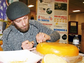Artist Thomas Cushing of Kitchener carves a scene into a large wheel of gouda during the Dairy Capital Cheese Fest in 2016. (Sentinel-Review file photo)