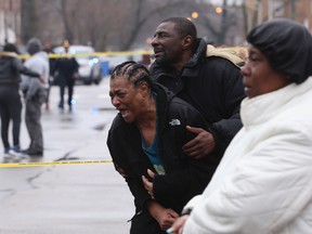 Georgia Jackson, 72, is overcome with emotion upon learning that her two grandsons, Raheem, 19, and Dillon Jackson, 20, were found fatally shot in the South Shore neighborhood in Chicago on Thursday, March 30, 2017. (Chris Sweda/Chicago Tribune via AP)