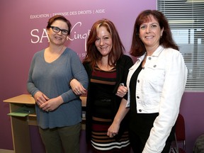 Lindsay Duggan, left, leading lady of One Hundred Women Who Care Kingston at the Sexual Assault Centre Kingston with Elyane Furoy, executive director and Dr Melanie Walker, a professor at the School of Medicine at Queen's University and member of the group. Ian MacAlpine /The Whig-Standard/Postmedia Network