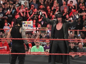 The Undertaker stares down his WrestleMania 33 opponent Roman Reigns during a recent episode of Raw. Sunday's match will be The Undertaker's 25th at WrestleMania. (George Tahinos/SLAM! Wrestling)