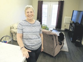 Retired nurse Sandra Peters stands in the living room of her apartment at 40 Cliff Cres. in Kingston on Friday.