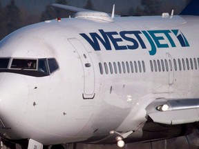 A pilot taxis a Westjet Boeing 737-700 plane.