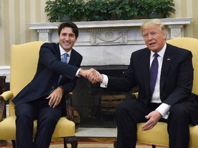 Prime Minister Justin Trudeau meets with U.S. President Donald Trump in the Oval Office of the White House, in Washington, D.C., on Feb. 13, 2017. Justin Trudeau is driving home the message that Canada and the United States share a special relationship that relies on the continued smooth flow of commerce across their border. The prime minister says that means jobs in both countries, a message Canada will continue to impress on the Americans as Donald Trump prepares to hold his country's major trading partners to account. (THE CANADIAN PRESS/Sean Kilpatrick)