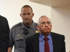 John Sandoval is escorted out of the courtroom after pleading guilty to second-degree murder at the Weld County Courthouse in Greeley, Colo., Friday, March 31, 2017. He led Greeley police to the remains of his wife Tina Tournai-Sandoval, last week in exchange for a lessor sentence. (Joshua Polson /The Greeley Tribune via AP)