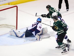 London Knights centre Mitchell Stephens scores the game-winning goal on Windsor Spitfires goaltender Michael DiPietro in the second period of Game 5 of their OHL Western Conference best-of-seven quarterfinal series Friday at Budweiser Gardens.  The Knights won 2-1 and trail the Spitfires 3-2 in the series. Game 6 is Sunday at 2 p.m. in Windsor. (MIKE HENSEN, The London Free Press)