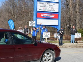 Members of three Sarnia-Lambton construction trades' unions staged an information picket outside of Lambton College Saturday to coincide with the college's annual spring open house. Union officials say its membership is frustrated about the use of out-of-town workers to build the college's new Nova Chemical Health and Research Centre, as well as an athletics and fitness complex. Barbara Simpson/Sarnia Observer/Postmedia Network