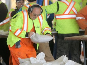 Sandbagging efforts continued on Saturday, but the city says it is well-positioned to handle diking efforts on the handful of endangered properties. (Winnipeg Sun/Postmedia Network)