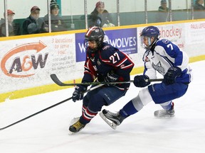 Abdul Abouzeeni, left, of the Windsor Spitfires, and Brady Maltais, of the Sudbury Nickel Capital Wolves, battle for the puck during action at the Central Region Midget AAA Championship at the Gerry McCrory Countryside Sports Complex in Sudbury, Ont. on Saturday April 1, 2017. John Lappa/Sudbury Star/Postmedia Network