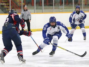 Thomas Michaud, left, of the Windsor Spitfires, passes the puck to a teammate as Tommy Vlahos, of the Sudbury Nickel Capital Wolves, attempts to deflect the pass during action at the Central Region Midget AAA Championship at the Gerry McCrory Countryside Sports Complex in Sudbury, Ont. on Saturday April 1, 2017. The Nickel Caps will host the Telus Cup nationals in April 2018. John Lappa/Sudbury Star/Postmedia Network