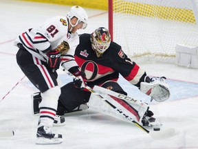 Ottawa Senators goalie Mike Condon keeps his eye on the puck as Chicago Blackhawks winger Marian Hossa tries to score in Ottawa on Thursday, March 16, 2017. (THE CANADIAN PRESS/Adrian Wyld)