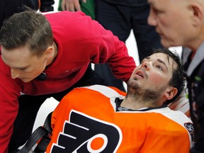 Philadelphia Flyers goalie Michal Neuvirth is taken off the ice on a stretcher after collapsing early in the first period against the New Jersey Devils Saturday, April 1, 2017, in Philadelphia. (AP Photo/Tom Mihalek)
