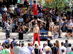 David Graham and Tobin Renwick (top) from The Red Trouser Show perform during the Edmonton International Street Performers Festival in Sir Winston Churchill Square, in Edmonton Alta., on Friday July 4, 2014. The festival runs until July 13. David Bloom/Edmonton Sun