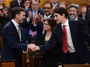 Prime Minister Justin Trudeau shakes hands with Minister of Finance Bill Morneau after he delivered the federal budget in the House of Commons on Parliament Hill in Ottawa, Wednesday March 22, 2017. THE CANADIAN PRESS/Sean Kilpatrick