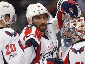 Washington Capitals left winger Alex Ovechkin (centre) and Lars Eller (left) congratulate goalie Philipp Grubauer after the Capitals defeated the Colorado Avalanche 5-3 on March 29, 2017, in Denver. (DAVID ZALUBOWSKI/AP)