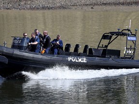 Police patrol the River Thames prior to the annual university Oxford-Cambridge boat race along the river, London, Sunday April 2, 2017.  (Andrew Matthews/PA Wire via AP)