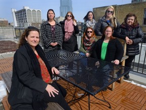 Cathy Nolan, seated left, of SLWAR, Rebecca Woloshyn, SLWAR, Jaclyn Seeler, SLWAR, Kaitlin Kelly, SLWAR, Jessika Lang, Unity Project, Cecilia Inguanse, My Sister's Place, seated right, Melanie Dutton, Supportive Independent Living, and Elizabeth Stacey, YOU. (MORRIS LAMONT, The London Free Press)