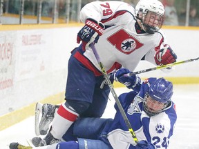 Mathieu Dokis-Dupuis of the Sudbury Nickel Capital Wolves and Eric Mondoux of the North Bay Trappers collide during the bronze medal game at the Central Region Midget AAA Championship in Sudbury, Ont. on Sunday April 2, 2017. Gino Donato/Sudbury Star/Postmedia Network