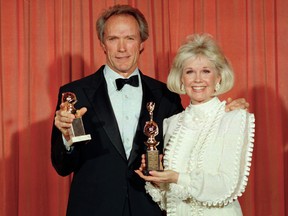 In this Jan. 29, 1989 file photo, Clint Eastwood poses with Doris Day at the 46th annual Golden Globe Awards in Beverly Hills, Calif. Eastwood won a Golden Globe for motion picture directing for his work on "Bird," and Day was honoured with the Cecil B. DeMille Award for her outstanding contribution to the film industry. The film and recording star Day is marking her birthday Monday, April 3, 2017, with a social media campaign to highlight her love of animals. (AP Photo/Douglas C. Pizac, File)