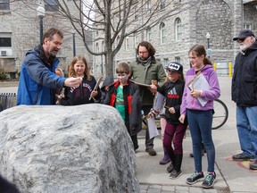 Mark Badham, curator at the Miller Museum of Geology at Queen's University, conducts a chemical test on a rock in front of Harley Gallagher's Grade 5 class from Molly Brant Elementary School on March 30. (Julia McKay/The Whig-Standard)