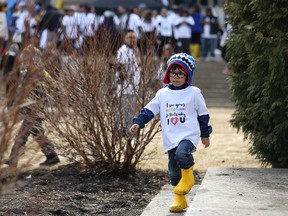 Carter Bayle, 4, of Petersfield, Man., who has autism, plays during the fifth annual World Autism Awareness Day Walk at the Manitoba Legislative Building in Winnipeg on Sun., April 2, 2017. (Kevin King/Winnipeg Sun/Postmedia Network)