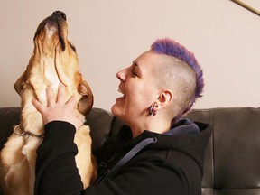 Sarah Thibault plays with her dog Fin at her home in Sudbury. (Gino Donato/Sudbury Star)