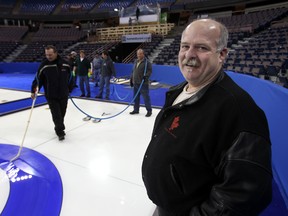 Head ice maker Jamie Bourassa, right, watches as ice crews work on the sheets for the 2013 Brier at Northlands Coliseum in Edmonton on Feb 26, 2013. (File)