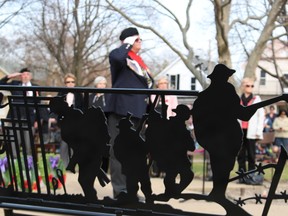 Sergeant-at-arms Bill Chafe, with Sarnia's Royal Canadian Legion, salutes during the singing of God Save the Queen at at the Vimy Ridge anniversary service held at Veteran's Park Sunday. Pictured in the foreground is a new bench for the park featuring the silhouettes of four soldiers to mark the 100th anniversary of the WWI battle. Four Sarnia soldiers were killed in the Battle of Vimy Ridge. Barbara Simpson/Sarnia Observer/Postmedia Network