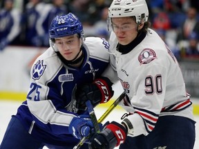 Sudbury Wolves' Owen Gilhula and Oshawa Generals' Danil Antropov keep an eye on the play during Game 6 between the Wolves and Gens at Sudbury Community Arena on Sunday night.