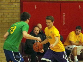 City team Logan Tinney, right, brings the ball up the court in front of county player Jackson Does in Woodstock, Ont. on Thursday March 30, 2017 at Woodstock Collegiate Institute during the annual junior and senior Captains/Veterans boy's basketball game. The city won the junior game 62-59 and the county won the senior game 80-72. Greg Colgan/Woodstock Sentinel-Review/Postmedia Network