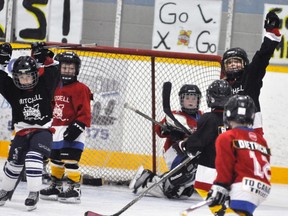 Ginny DeJong (right) raises her arms on her goal for the Senators midway through the Junior HL ‘A’ final, putting a stamp on a 9-4 win against the Canadiens. Also with his arms raised is teammate Caleb Pennings. ANDY BADER/MITCHELL ADVOCATE