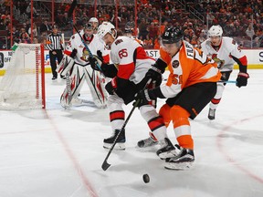 Erik Karlsson #65 of the Ottawa Senators checks Valtteri Filppula #51 of the Philadelphia Flyers during the second period at the Wells Fargo Center on March 28, 2017 in Philadelphia, Pennsylvania. (Photo by Bruce Bennett/Getty Images)