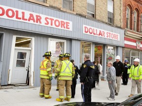 Firefighters, OPP and building officials inspect the damage caused to the Dollar Store at 56 Ontario Rd., Mitchell Monday after a vehicle struck the building. ANDY BADER/MITCHELL ADVOCATE